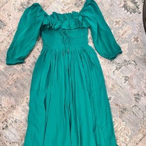 Emerald green dress can be worn on or off the shoulder. Size M, like new